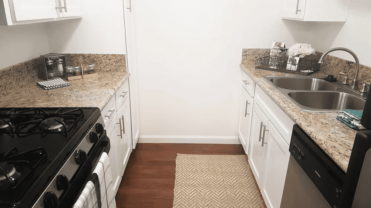 Pico Rivera Collection galley kitchen layout with granite style countertops
